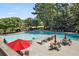 Community pool with lounge chairs and umbrellas at 89 Chaumont Nw Sq, Atlanta, GA 30327