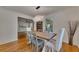 Bright dining room with hardwood floors, modern chandelier, and view into living room at 1887 Hickory Rd, Chamblee, GA 30341