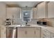 Modern kitchen with white cabinets, stainless steel appliances, and quartz countertops at 1887 Hickory Rd, Chamblee, GA 30341