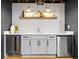 Modern basement bar with gray cabinetry, floating shelves, and wine cooler at 2152 Tourney Dr, Marietta, GA 30062