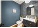 Stylish powder room with blue walls, patterned tile, and modern vanity at 2237 Gunstock Dr, Stone Mountain, GA 30087
