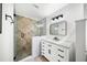 Clean bathroom with updated vanity, mirror and shower at 2237 Gunstock Dr, Stone Mountain, GA 30087