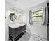 Updated bathroom with double vanity, modern fixtures, and geometric tile floor at 2237 Gunstock Dr, Stone Mountain, GA 30087