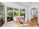 Bright breakfast nook with a wooden table and chairs, surrounded by windows at 2237 Gunstock Dr, Stone Mountain, GA 30087