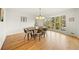 Spacious dining area with hardwood floors, large windows, and modern dining set at 2237 Gunstock Dr, Stone Mountain, GA 30087