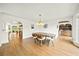 Bright dining room with hardwood floors, modern chandelier, and views into kitchen and wet bar at 2237 Gunstock Dr, Stone Mountain, GA 30087