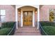 Double wood front doors with brick entryway and railings at 2237 Gunstock Dr, Stone Mountain, GA 30087