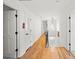 Long hallway with hardwood floors and access to bedrooms at 2237 Gunstock Dr, Stone Mountain, GA 30087