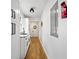 Long hallway with white cabinets, wood floors, and a view to the dining area at 2237 Gunstock Dr, Stone Mountain, GA 30087