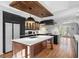 Updated kitchen boasts an island, custom cabinetry, and stylish backsplash at 2237 Gunstock Dr, Stone Mountain, GA 30087