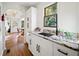 White kitchen with granite countertops and a view to the dining area at 2237 Gunstock Dr, Stone Mountain, GA 30087