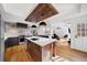 Modern kitchen with large island, dark cabinetry, and wood beam accent at 2237 Gunstock Dr, Stone Mountain, GA 30087