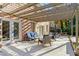 Covered patio with pergola, string lights and comfortable seating at 2237 Gunstock Dr, Stone Mountain, GA 30087