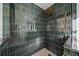 Walk-in shower with dark green tile and rainfall shower head at 2237 Gunstock Dr, Stone Mountain, GA 30087