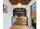 Stylish wet bar featuring a hexagon tile backsplash and wood cabinetry at 2237 Gunstock Dr, Stone Mountain, GA 30087