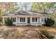 White Ranch home with front porch, mature trees, and landscaping at 3455 Andrea Lee Ct, Snellville, GA 30039