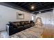 Finished basement Gathering room with leather couch and wood floors at 5088 Riverview Rd, Atlanta, GA 30327