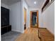 Bright hallway featuring wood floors, a bench, and access to a powder room at 5088 Riverview Rd, Atlanta, GA 30327