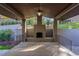 Covered patio with stone fireplace and seating area at 5088 Riverview Rd, Atlanta, GA 30327