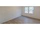 Well-lit bedroom featuring wood-look floors and a window at 4639 Hardwood Rd, Stone Mountain, GA 30083