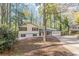 House exterior showcasing a yellow and white color scheme and a tree-lined setting at 4639 Hardwood Rd, Stone Mountain, GA 30083