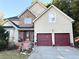 Two-story house with stone accents and a red door at 3668 Deer Springs Pkwy, Ellenwood, GA 30294