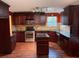 Kitchen with dark wood cabinets, granite counters, and island at 3668 Deer Springs Pkwy, Ellenwood, GA 30294