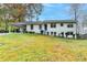 White ranch house with a blue door, carport, and landscaped yard at 244 Mirandy Way, Lawrenceville, GA 30044