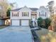 Two-story house with attached two-car garage and landscaped yard at 515 Anthony Pl, Canton, GA 30114