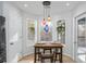 Kitchen nook with a wood table and three stools, overlooking a wooded area at 515 Anthony Pl, Canton, GA 30114