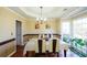 Bright dining room with hardwood floors, large windows, and a formal dining set at 570 Hunt River N Way, Suwanee, GA 30024