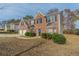 Brick two-story house with a two-car garage, and neat landscaping at 915 Lake Dr, Snellville, GA 30039