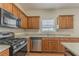 View of kitchen with stainless steel appliances and wood cabinets at 915 Lake Dr, Snellville, GA 30039