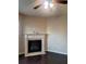 Living room featuring a fireplace and dark hardwood floors at 1212 Lake Point Way, Suwanee, GA 30024