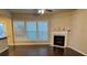 Living area with fireplace, windows, and hardwood flooring at 1212 Lake Point Way, Suwanee, GA 30024