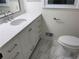 Updated bathroom with white vanity, quartz countertop, and marble floor at 1463 Martin Nash Sw Rd, Lilburn, GA 30047