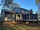 Gray siding two-story house with screened porch and yard at 1463 Martin Nash Sw Rd, Lilburn, GA 30047