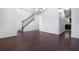 Formal dining room with dark hardwood floors, white wainscoting, and a view of the staircase at 5992 Mock Ives Ct, Sugar Hill, GA 30518