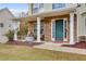 Covered porch with stonework, seating, and landscaping at 178 Birchwood Dr, Temple, GA 30179