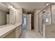 Double vanity bathroom with shower, marble tile floors and neutral tones at 611 Mason Grove Pkwy, Lawrenceville, GA 30043