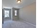 Bright bedroom with carpet flooring, neutral walls, and two windows at 611 Mason Grove Pkwy, Lawrenceville, GA 30043