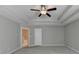 Large main bedroom with carpet, ceiling fan, and door to en-suite bathroom at 611 Mason Grove Pkwy, Lawrenceville, GA 30043