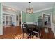 Dining room with hardwood floors, chandelier, and light green walls at 645 Wexford Ct, Acworth, GA 30102