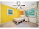 Bedroom with ceiling fan, closet, and yellow accent wall at 1874 Old Lost Mountain Rd, Powder Springs, GA 30127