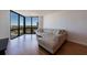 Living room with large corner windows, hardwood floors, and a sectional sofa at 2870 Pharr Court South Nw # 2602, Atlanta, GA 30305