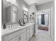 Bathroom with double vanity, view into bedroom, and patterned tile floor at 392 Pratt Se Dr # 2023, Atlanta, GA 30315