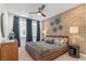 Spacious bedroom with brick feature wall, king-size bed, and ceiling fan at 392 Pratt Se Dr # 2023, Atlanta, GA 30315