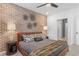Primary bedroom with brick accent wall and leather bed at 392 Pratt Se Dr # 2023, Atlanta, GA 30315