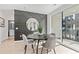 Dining area with gray accent wall, round table, and balcony access at 392 Pratt Se Dr # 2023, Atlanta, GA 30315