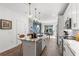 Modern kitchen with white cabinets, island, and gold light fixtures at 392 Pratt Se Dr # 2023, Atlanta, GA 30315